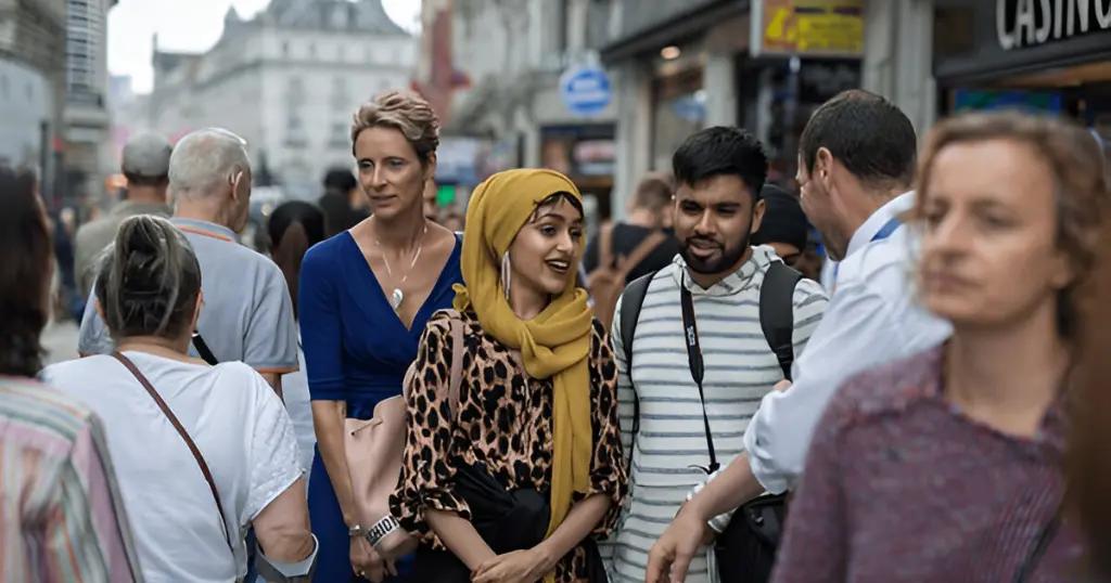 A diverse group walking on a busy UK street. UK Visit Visa from Pakistan allows travelers to explore vibrant city life.