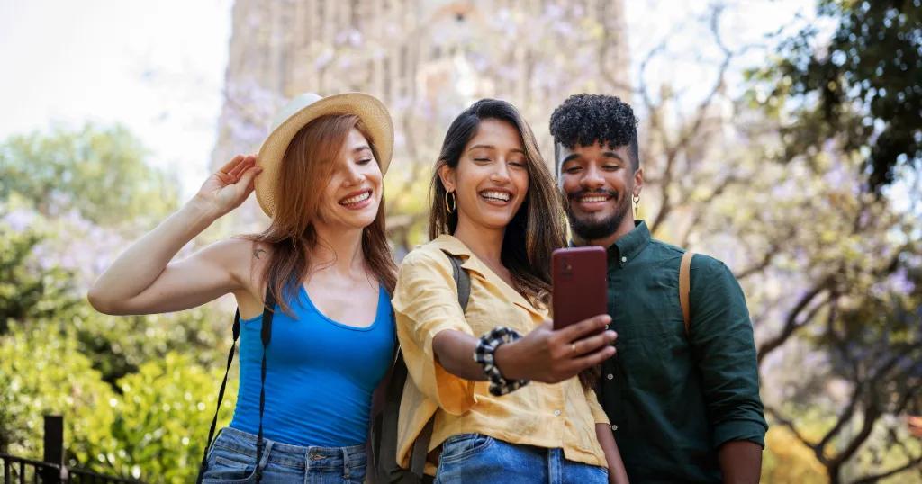 A group of friends taking a selfie while exploring new destinations, celebrating their successful UK Visa applications.